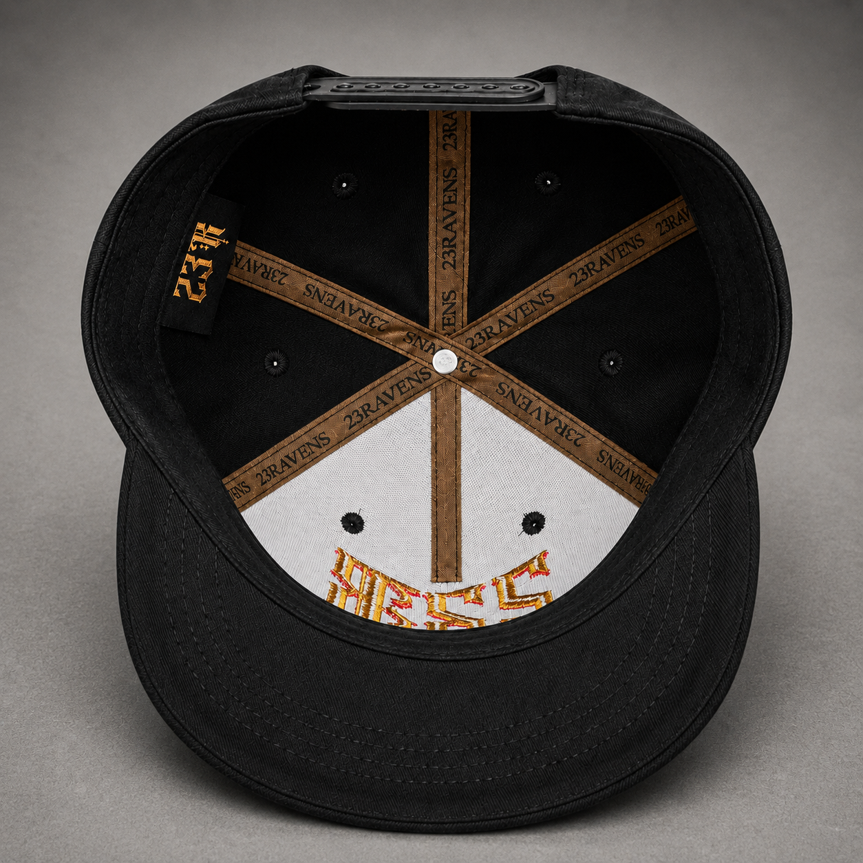 Interior detail of 23Ravens snapback cap showing premium branded taping and embroidery
