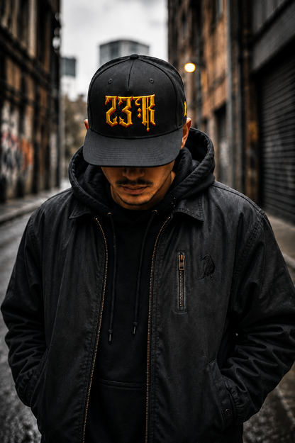 Model wearing black 23Ravens snapback cap in dark urban streetwear setting