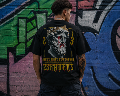 Back view of model wearing black 23Ravens oversized t-shirt with gothic graphic print in urban street setting