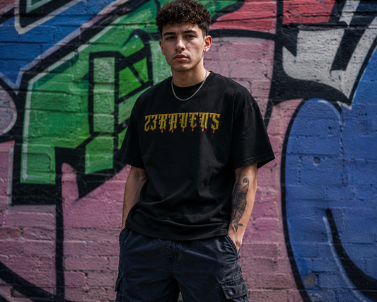 Model wearing black 23Ravens oversized t-shirt with gothic gold logo in urban streetwear setting