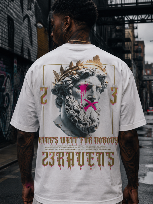 Back view of model wearing white 23Ravens oversized t-shirt with gothic graphic print in urban street setting