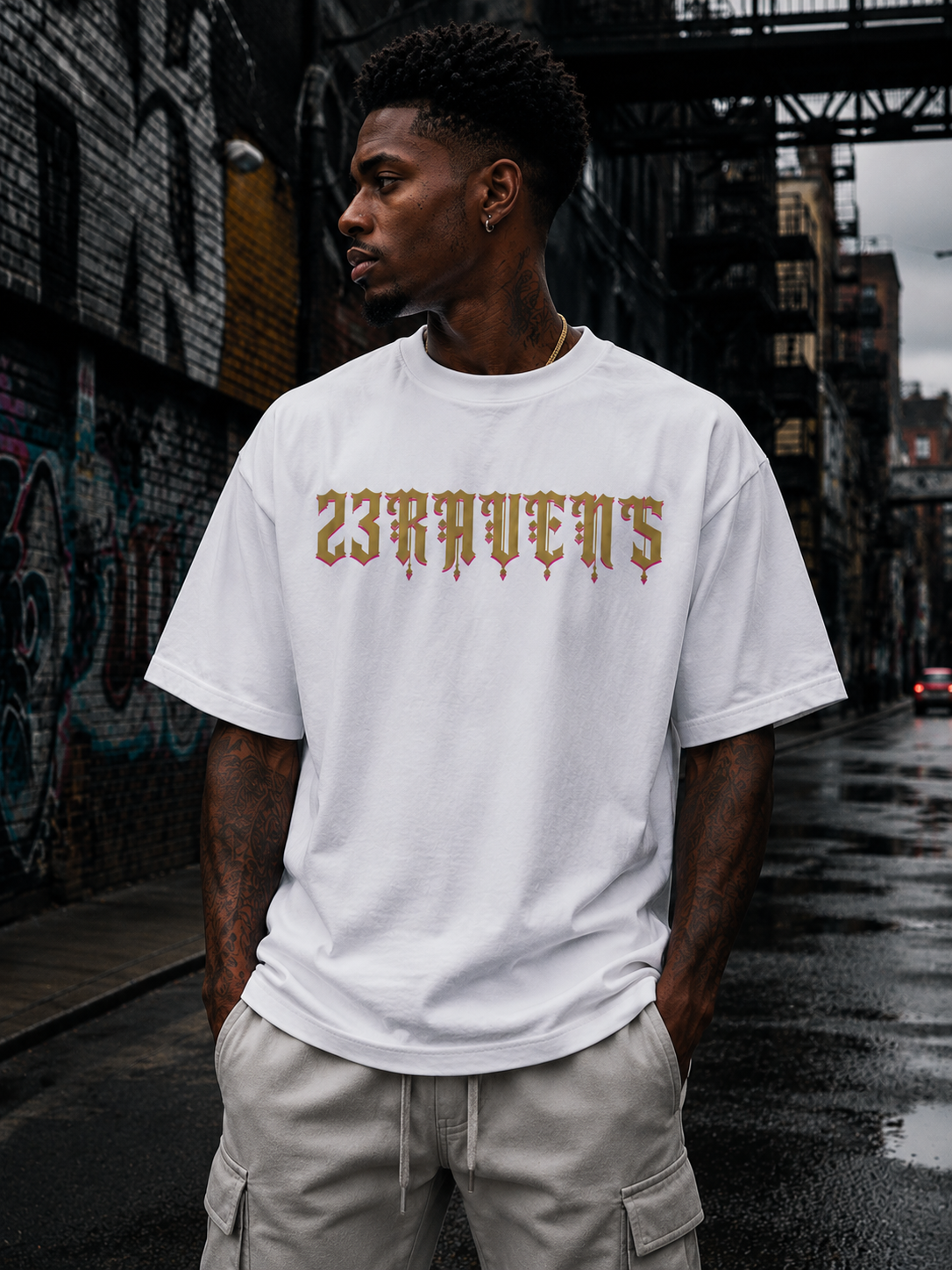 Model wearing white 23Ravens oversized t-shirt with gothic gold logo in urban streetwear setting